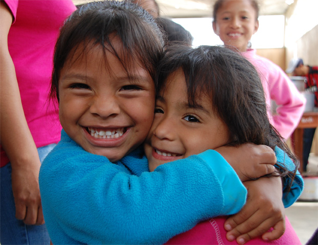 Maria (left), age 5, two years after joining the NPH Peru family