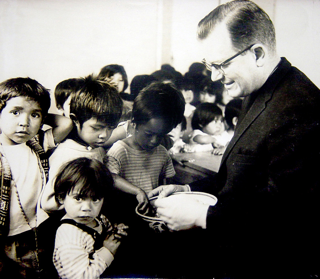 https://nphusa.org/wp-content/uploads/2024/06/1956-fr.-wasson-feeding-kids-1.jpg